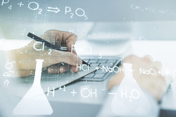 Poster - Double exposure of creative chemistry concept with hand writing in notebook on background with laptop, research and development concept