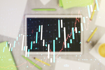 Poster - Abstract creative financial graph and modern digital tablet on desktop on background, top view, financial and trading concept. Multiexposure