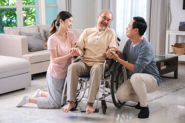 Asian family person health care and insurance at home concept, man and daughter woman take care support to senior elderly father patient in wheelchair together, having smile in happy love lifestyle