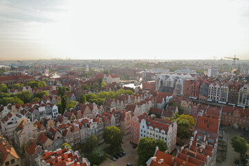 Wall Mural - Beautiful panoramic architecture of old town in Gdansk, Poland at sunrise. Aerial view drone pov. Landscape cityscape City from Above. Small vintage historical buildings Europe Tourist Attractions