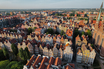 Wall Mural - Beautiful panoramic architecture of old town in Gdansk, Poland at sunrise. Aerial view drone pov. Landscape cityscape City from Above. Small vintage historical buildings Europe Tourist Attractions