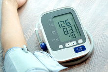 Man Check Blood Pressure Monitor And Heart Rate Monitor With Digital Pressure Gauge. Health Care And Medical Concept