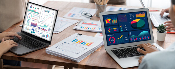 Fototapete - Panorama shot analyst team utilizing BI Fintech to analyze financial report with laptop. Businesspeople analyzing BI power dashboard displayed on laptop screen for business insight. Scrutinize