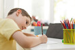© Westend61 - Boy in concentration learning to draw with colored pencil at home