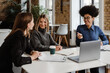 © Drobot Dean - Three smiling women having conversation while working in office