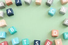 Wooden Cubes With English Letters On A Pastel Green Background. ABC Learning, Education And Language Concept