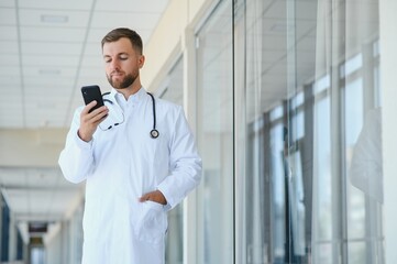 Wall Mural - Portrait of a male doctor standing in a hospital corridor.