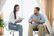 © Serhii - Portrait of female psychiatrist interviewing handicapped man during therapy session, copy space.