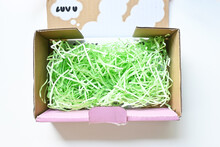 Open up delivery box filled with shredded paper or gift box filler. Creativity wrapping