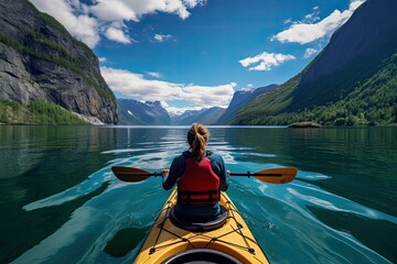 Wall Mural - View from the back of a girl in a canoe floating on the water among the fjords.