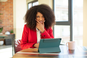 Wall Mural - pretty afro black woman with mouth and eyes wide open and hand on chin. businesswoman and laptop concept