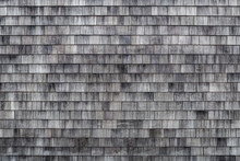 Weathered Wooden Shingles Background. Cedar Shake Siding Pattern For Wooden Texture Background. Wooden Roof Shingles. Wood Roofing Pattern Detail. Old Grey Black And White Wooden Roof Texture.