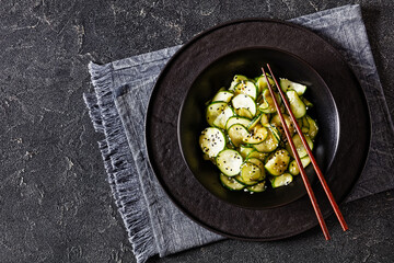 Wall Mural - Sunomono, Japanese Cucumber Salad in a black bowl