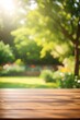 Wooden table top on blur background of green garden with bokeh sunlight. High quality photo

