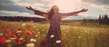Woman Embracing Life Standing Outside In Beautiful Meadow With Her Arms Raised High