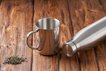 Stainless steel mug on an old wooden table.