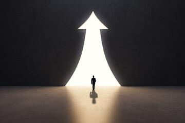 Poster - Back view of businessman silhouette in abstract concrete interior with upward arrow opening. Success, financial growth and future concept.