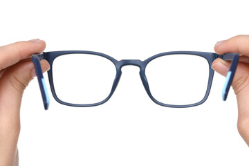 Woman holding stylish glasses with blue frame on white background, closeup