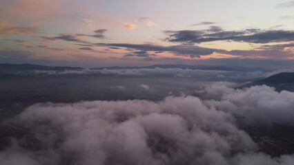 Wall Mural - Flying above the clouds. Aerial view of clouds and sunset sun. Traveling by air perfect background, panorama 4k