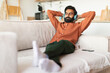 © Prostock-studio - Middle Eastern man resting with headphones enjoying favorite music indoor
