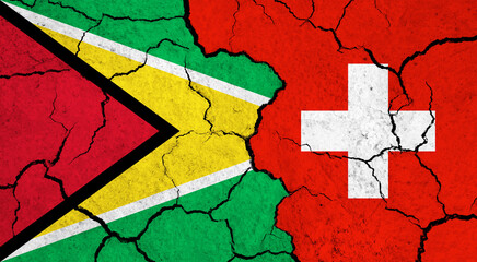 Flags of Guyana and Switzerland on cracked surface - politics, relationship concept