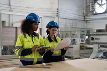 Two Female Engineer Worker Working And Planing Of Work In Industry Factory. Group Of Female Workers In The Factory