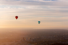 Aerial View Of Hot Air Balloons At Sunset Flying Over Melbourne Downtown District, Victoria, Australia.