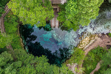 Aerial View Of Madison Blue Spring State Park With Stairs Going Down Into The Water And Vegetation Growing All Around The Hole In The Town Of Lee, Florida, United States.