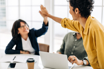 Canvas Print - Female colleagues celebrating success in an office