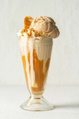 Sticker - Glass of a creamy orange milkshake topped with ice cream