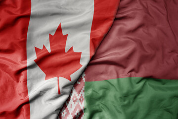 big waving realistic national colorful flag of canada and national flag of belarus .