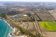 © AmazingAerialAgency - Aerial view of an industrial area along the coastline in Connewarre, Victoria, Australia.