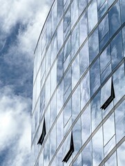 Wall Mural - Clouds reflected in a glass skyscraper