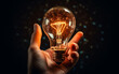 © Aleksandr - Hand holding a glowing light bulb.