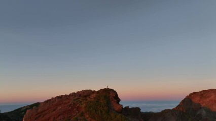 Wall Mural - Landscape aerial scene of rocky range cliffs with orange sunset sky on the horizon