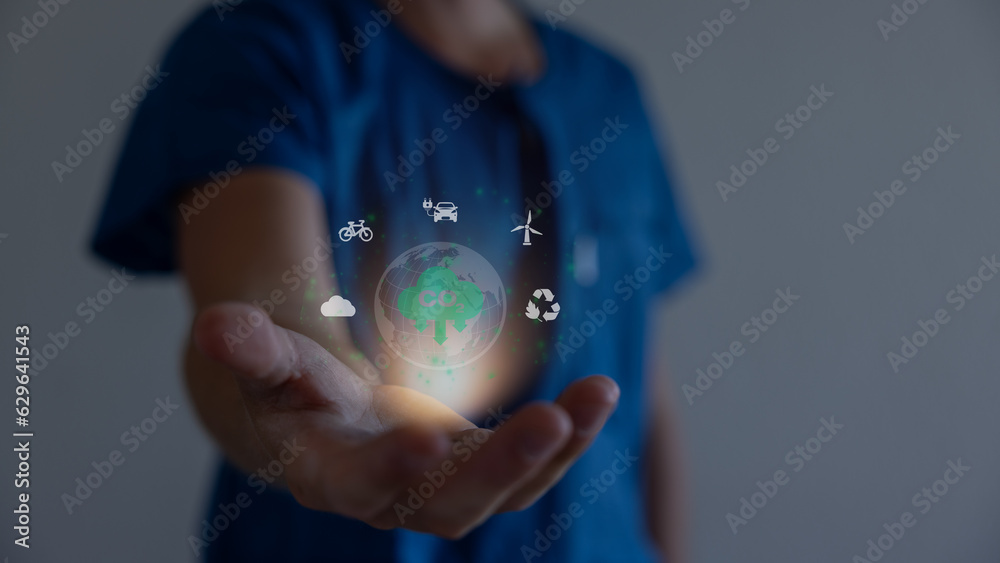 Hand holding virtual Global with CO2 reducing icon for concept of ...