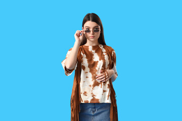 Sticker - Stylish young woman in tie-dye t-shirt on light blue background