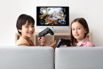 Wall Mural - Little children playing video game at home