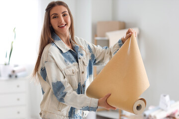 Canvas Print - Young woman with wallpaper roll at home