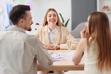 Wall Mural - Female wedding planner working with couple in office