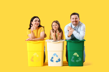 Wall Mural - Family with recycle bins on yellow background