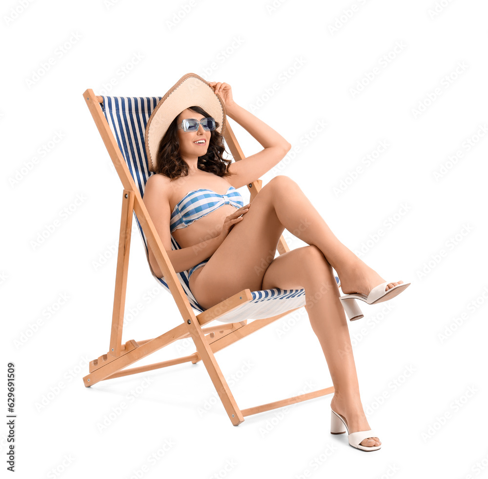 Young woman in deck chair on white background