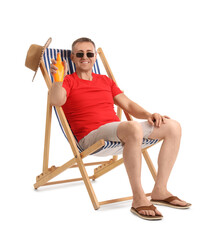 Canvas Print - Mature man with sunscreen cream relaxing in deck chair on white background