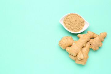 Fresh ginger root and bowl with dried powder on turquoise background