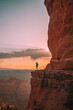 © travnikovstudio - Young hiker woman on the edge of a cliff at Cathedral Rock in Sedona, Arizona. View from Scenic Cathedral Rock in Sedona with blue sky in Arizona