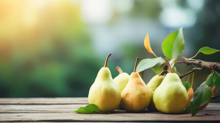 Yellow pears on grey wooden tabletop on blur garden background