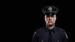 © Kordiush - Portrait of a policeman in uniform. He is on the right side of the frame. Dark background with space for text
