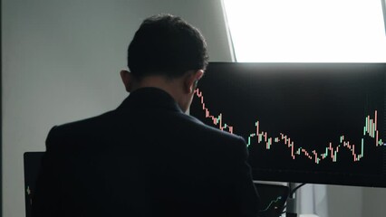 Aufkleber - Back view of stock market broker in analyzing data and graphs on multiple computer screens while sitting in modern office.
