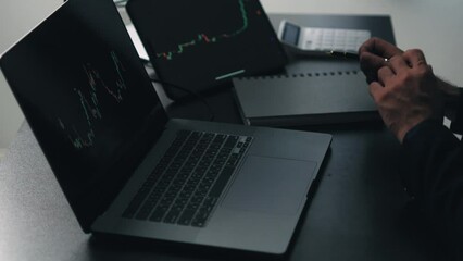 Aufkleber - Back view of stock market broker in analyzing data and graphs on multiple computer screens while sitting in modern office.