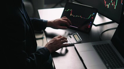 Aufkleber - Back view of stock market broker in analyzing data and graphs on multiple computer screens while sitting in modern office.